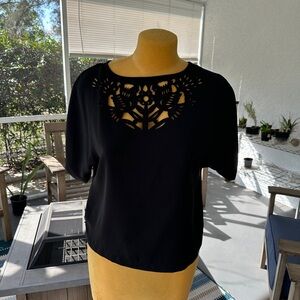Rachel Roy black dolman sleeve blouse with a laser-cut floral and bird pattern